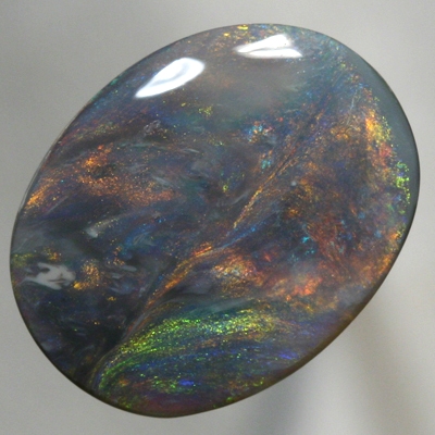SOLID BLACK OPAL Large opal with moving orange, green and blue SEE VIDEO